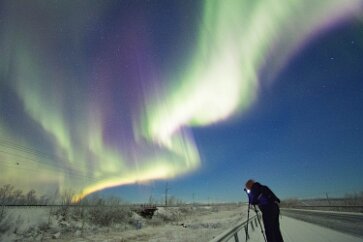Photographing Aurora As ribbons of northern light drift above us, another aurora photographer arranges her next shot. The technique is not difficult and the results on the small...