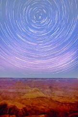 Grand Canyon Trails Overlooking the Grand Canyon from the South Rim on a moonless night. Wispy clouds travel through, creating a staccato effect on the startrail arcs. Grand Canyon...