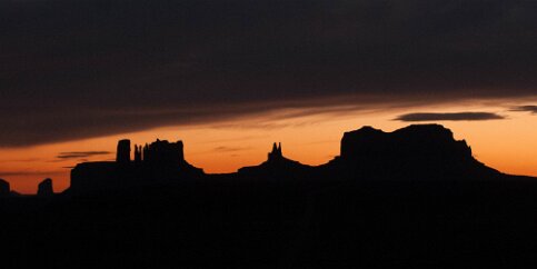 Monumental Sunset As I approached the Navaho Nation, the sun set and I was able to take this photo of Monument Valley from afar, silhouetted by the glowing sky. Monument Valley,...