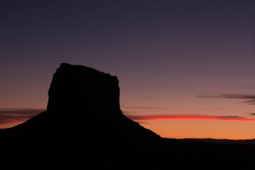 One Day Moon and Monument A beautiful composition where a very young moon, maybe less than a day old, following a short distance behind the setting sun, accents the sky. Monument Valley,...