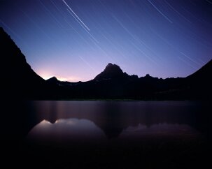 Swiftcurrent Moonset In front of the Many Glacier Hotel is Lake Josephine, a candidate for my quest for reflected startrails. On the night I was here however, so was the moon. I...