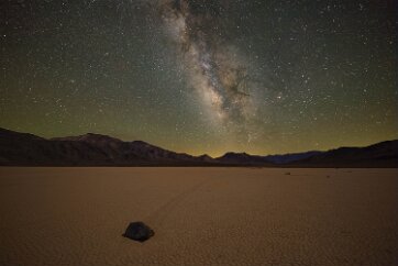 Milky Way Sails over the Playa The Milky Way moves slowly across the sky above one of the famous “sailing stones” on Racetrack Playa in Death Valley, an IDA dark sky park. The stones are...