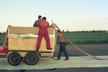 19770500 Balloon Launch T11-09 The balloon is carefully extracted from its container and laid out along the runway.
