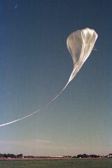 19770500 Balloon Launch T11-29 The spool opens (lower right) and the balloon rises, lifting its tail off the runway.