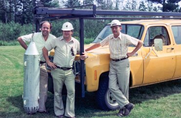 DownholeMagnetometer-3 Clark Johnson, Steve Haverberg and US Steel engineer Les Laun, posing with the downhole magnetometer system on a grassy lawn. Prior testing provided the...