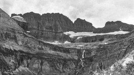 19700800-GrinnellGlacierHike-2 The Grinnell Glacier cirque in 1970. The glacier-carved amphitheater hosts famous features in Glacier National Park. The east side of the Garden Wall is the...