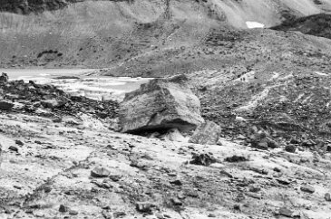 19700800-GrinnellGlacierHike-7 A large boulder on the surface of Grinnell Glacier. It will travel with the flow of the glacier and eventually be dropped somewhere along the glacial valley...