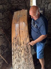 IMG_7030 Mario explains this odd sled embedded with sawblade segments. It's for crushing grains.