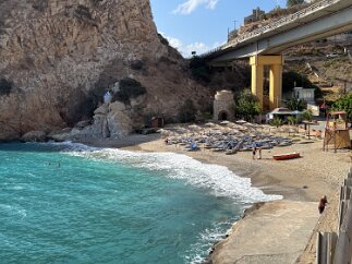 IMG_7078 A roadside beach featuring a stone remnant of a windmill.