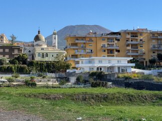 IMG_7484 We walk to the train station in the neighboring town of Torre del Greco. Mt Vesuvius looms in the background.